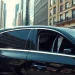 Experience luxury travel with a professional london chauffeur in a sleek black sedan.
